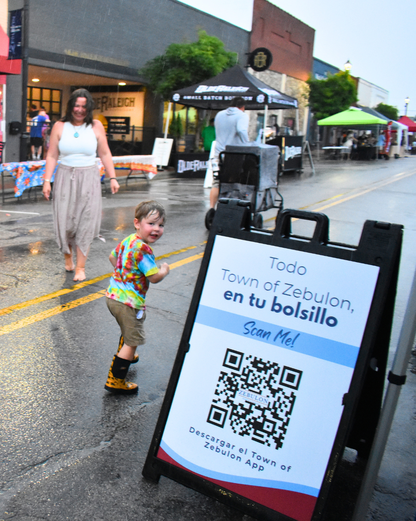 little boy in the rain at spring fest