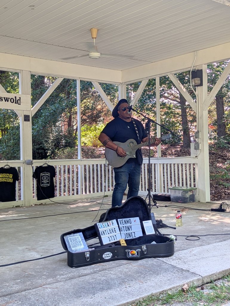 Performer singing and playing guitar.