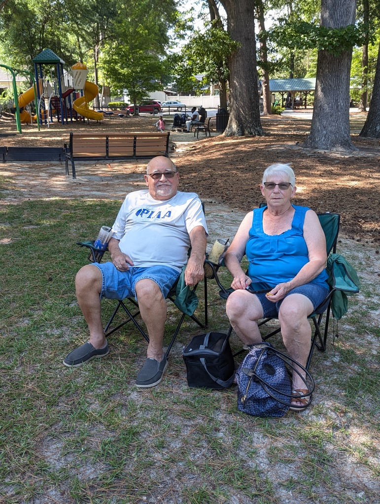 Two attendees sitting in lawn chairs.