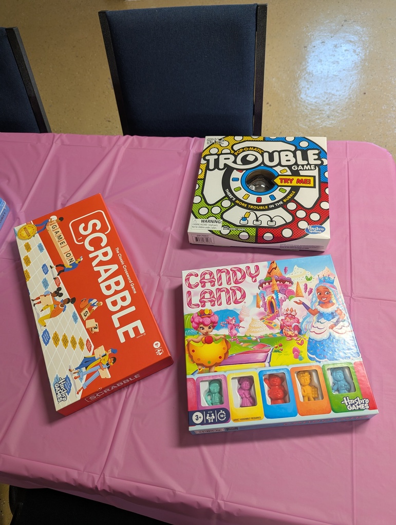 Assortment of board games (Scrabble, Candy Land, and Trouble)