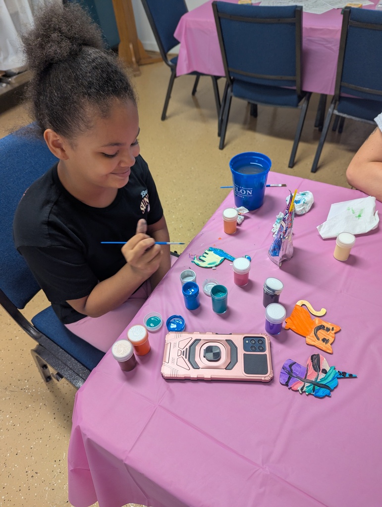 Child painting wooden crafts