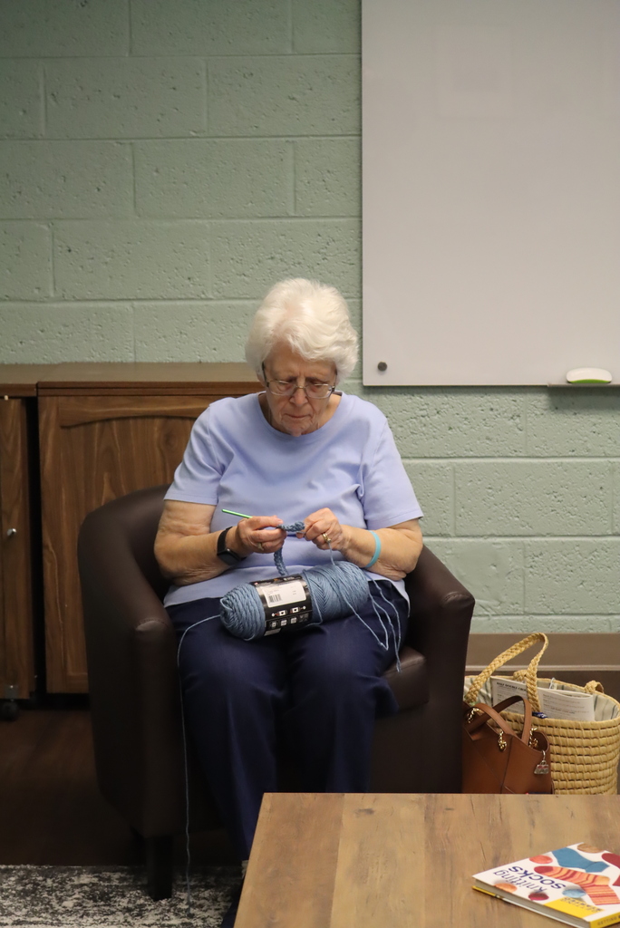 Woman sitting in a chair, knitting
