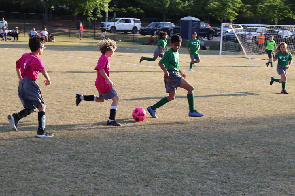 Children running after the soccer ball