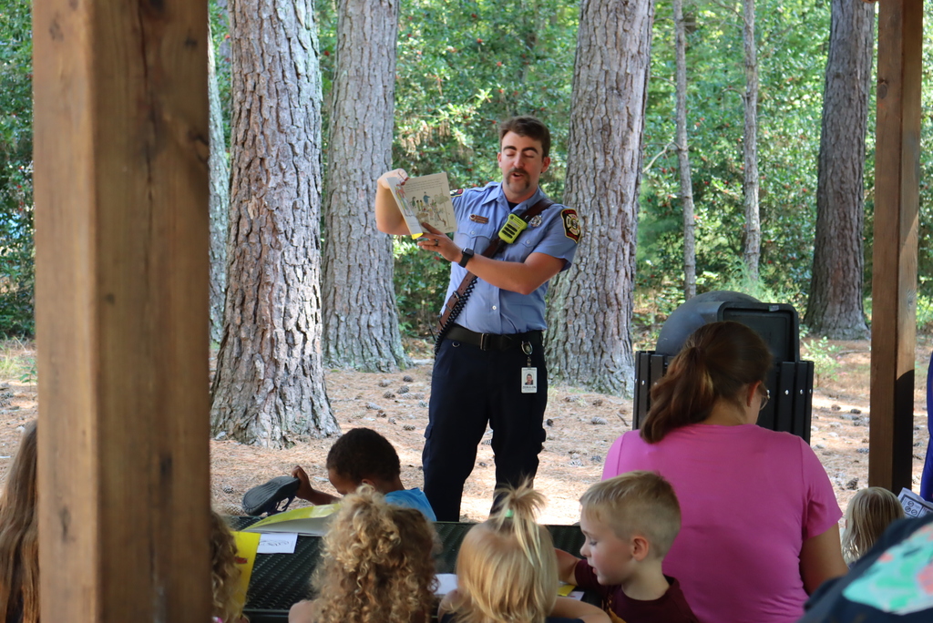 Firefighter reading a book to the children during story time