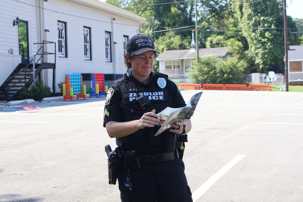 Police officer reading a book at storytime