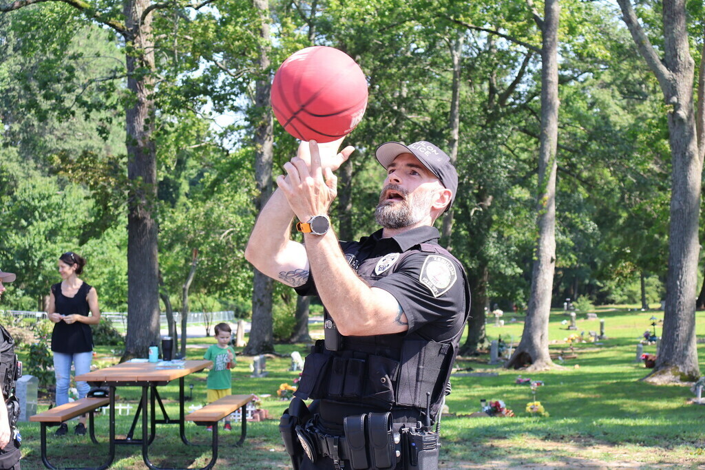 Police officer spinning a basketball on his finger