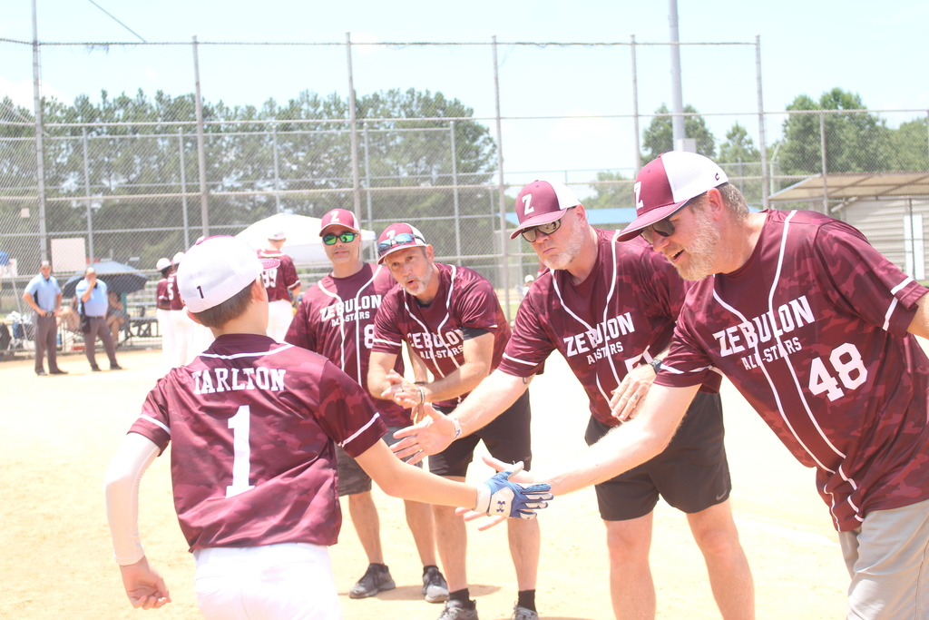coaches giving a baseball player a high five
