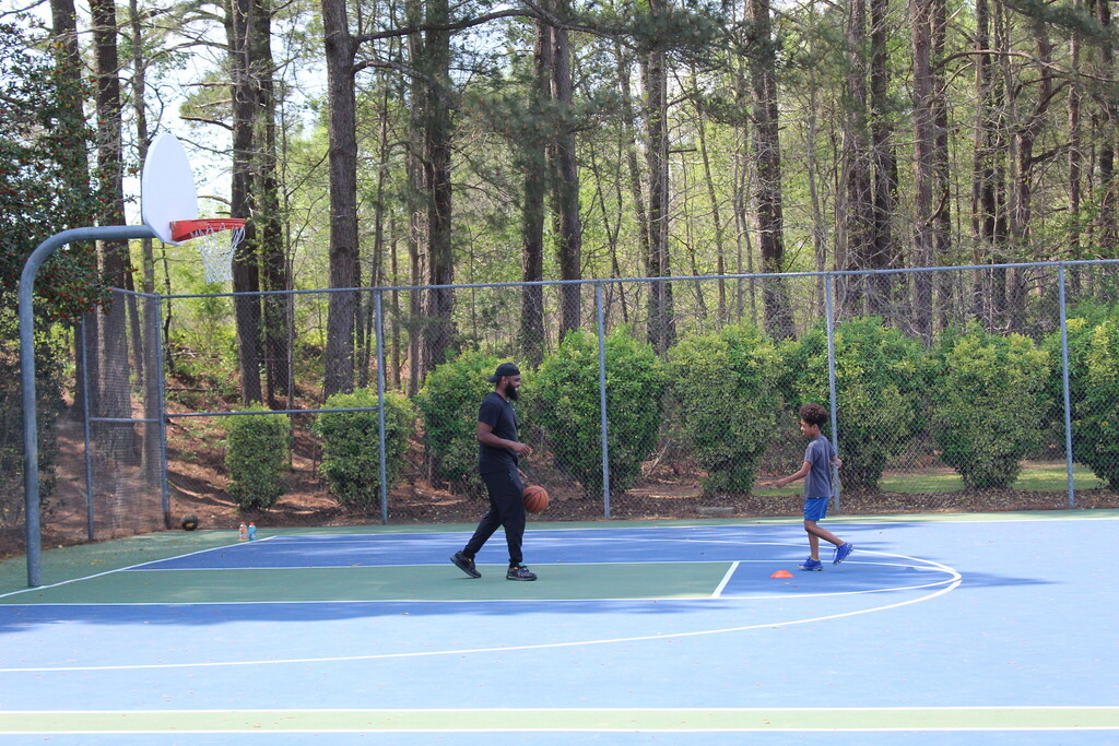 Father playing basketball with his son.