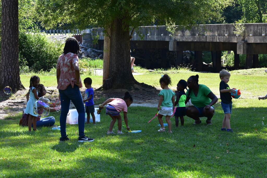 Children in the park playing with bubbles