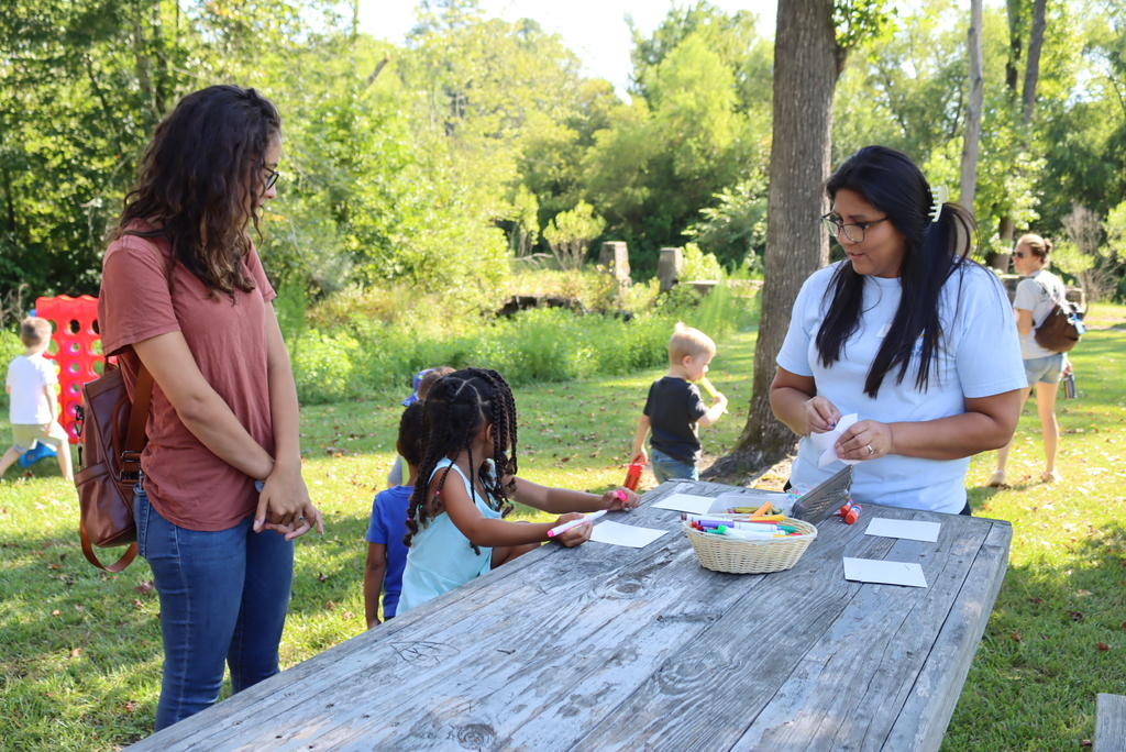 Family gathered around a picnic table doing a craft