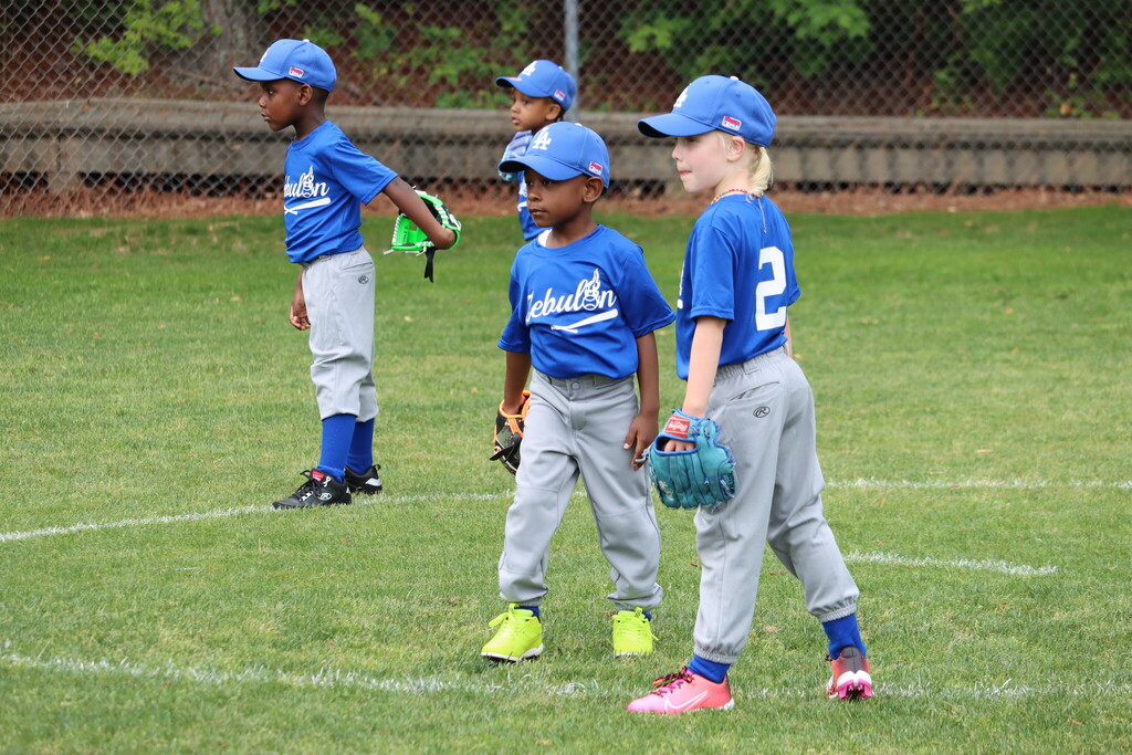 Four children playing baseball