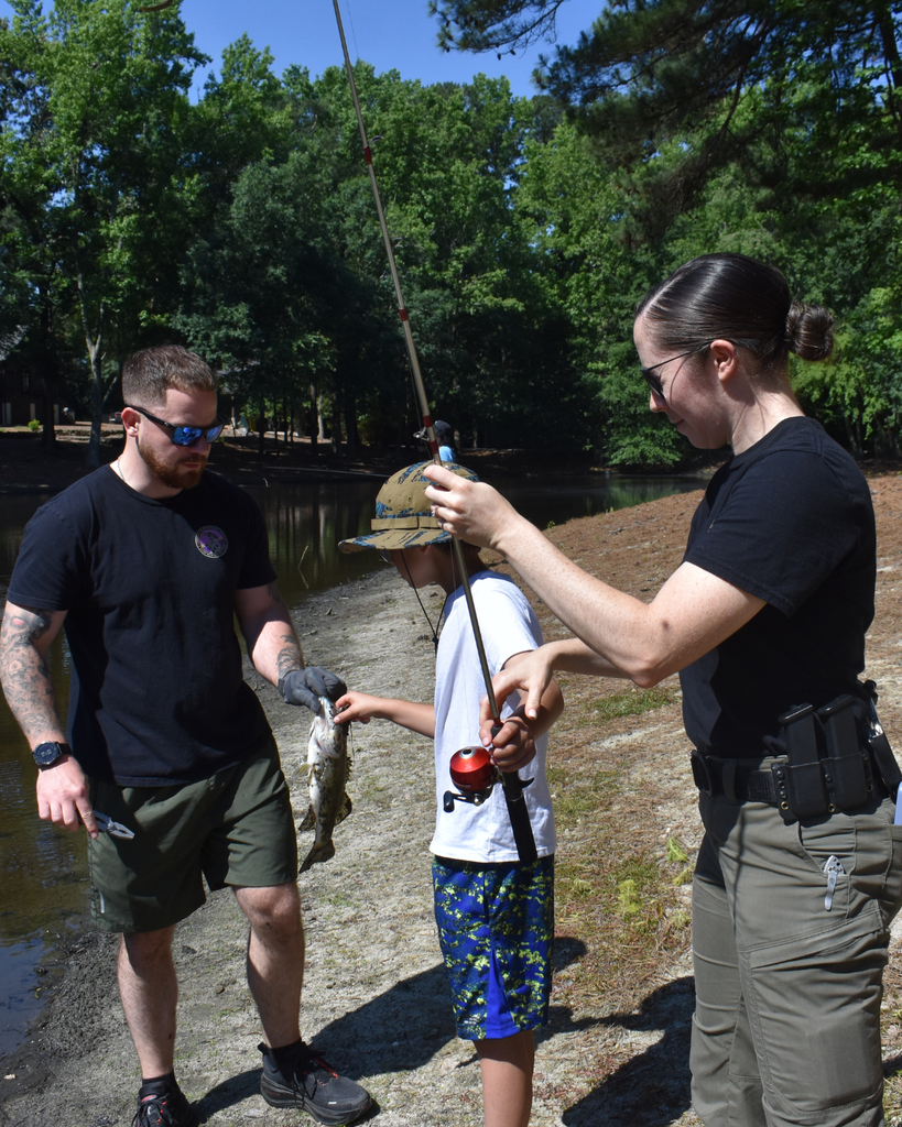 2 officers and a child fishing