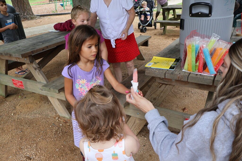 Children getting a popsicle.