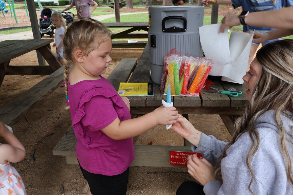 A child receiving a popsicle.