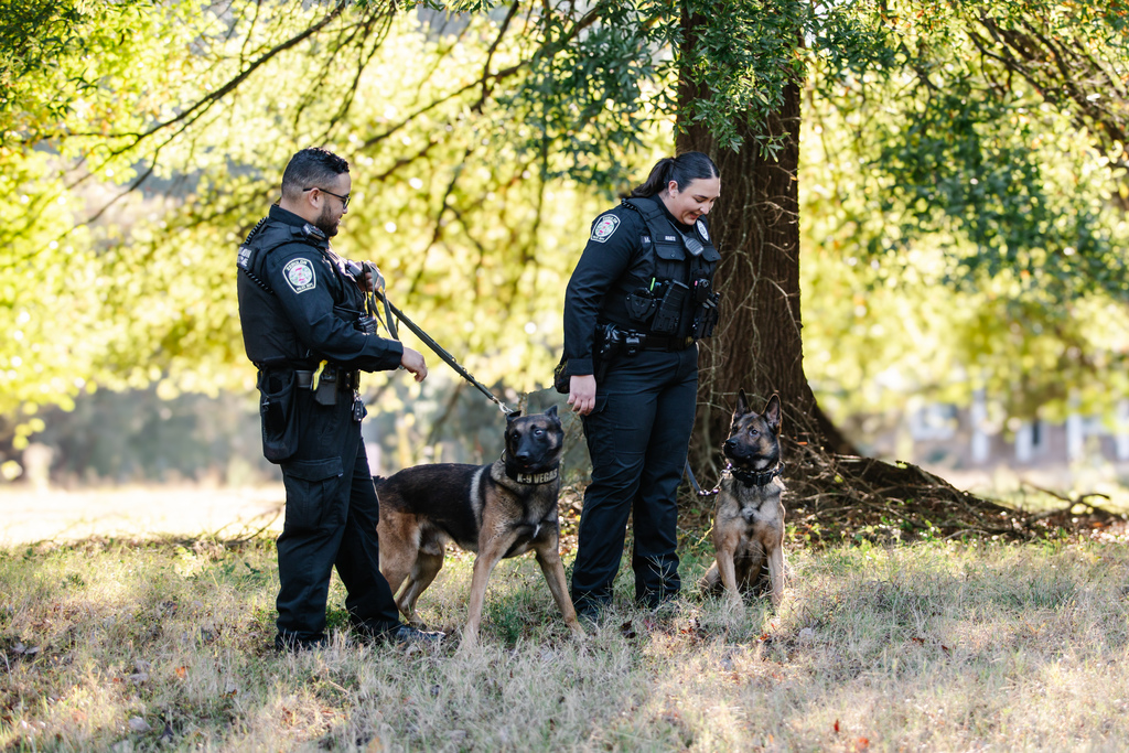 photo of two officers and two dogs