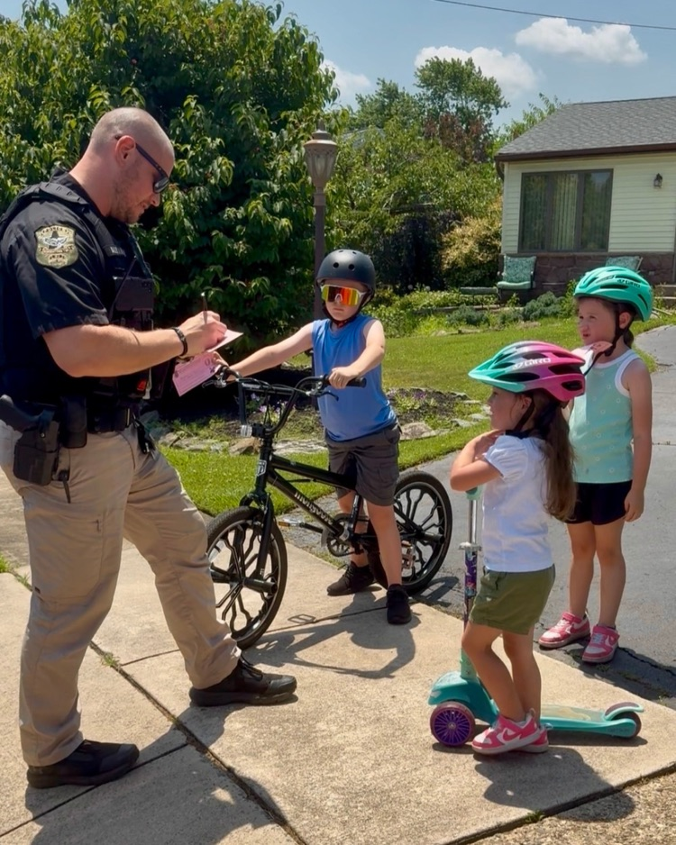 Operation Safe Summer is ON! Police officer gives kids an “ice cream ticket” for wearing their bike helmets