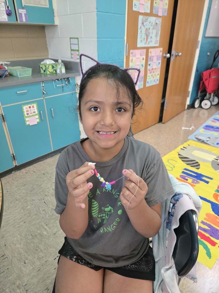 PFE camper making a bracelet at MLL camp