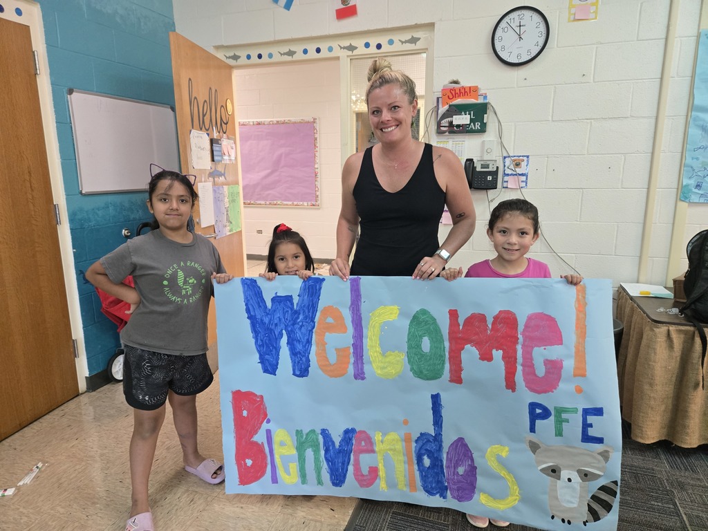 MLL teacher and campers with sign