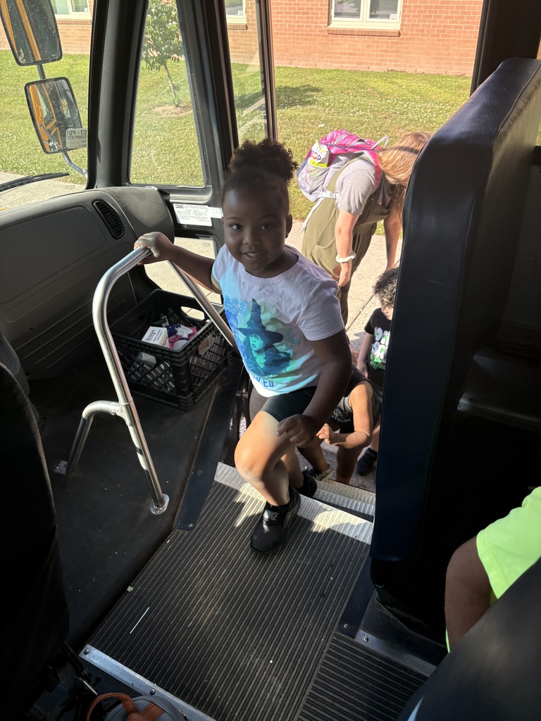 Big smiles as student climbs the bus steps