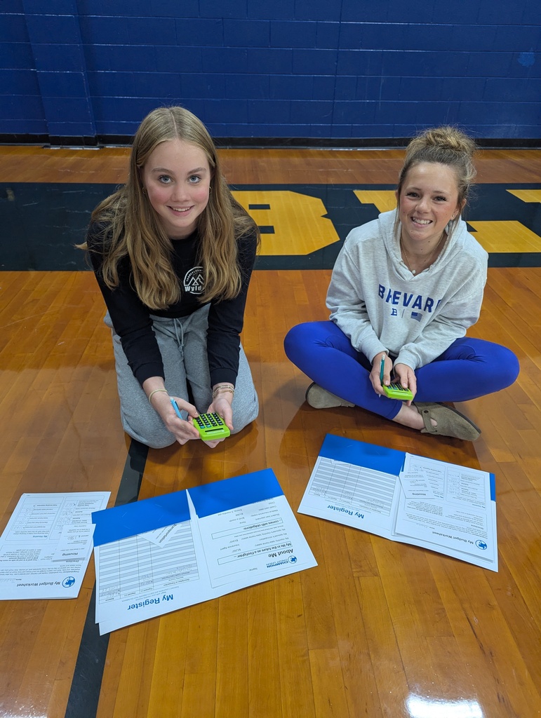 students smiling on gym floor 