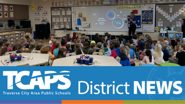 image of teacher in front of elementary classroom teaching