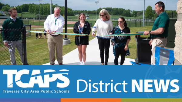 image of six individuals cutting celebratory opening ribbon for park.