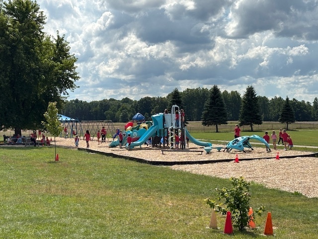 Look at all the red shirts on the playground!