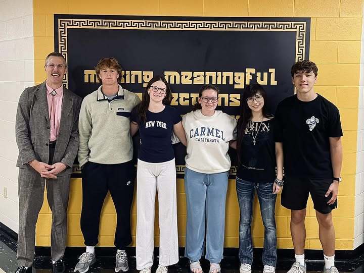 students standing  against the school wall