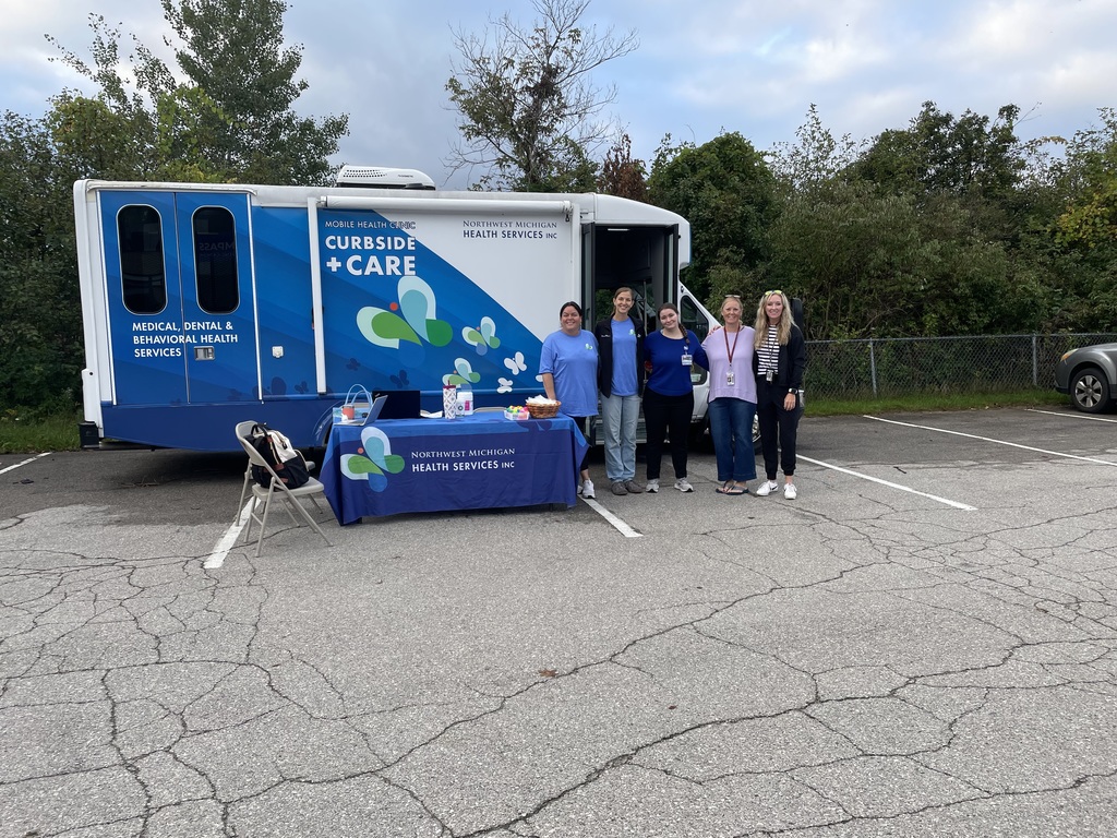 Several members of TC High staff and Northwest Michigan Health Services pose along side the Mobil Health Unit
