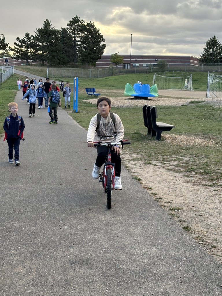 student on bike, kids in background