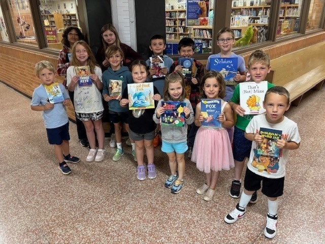 students holding books