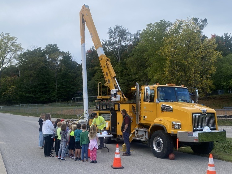 Students standing by a truck
