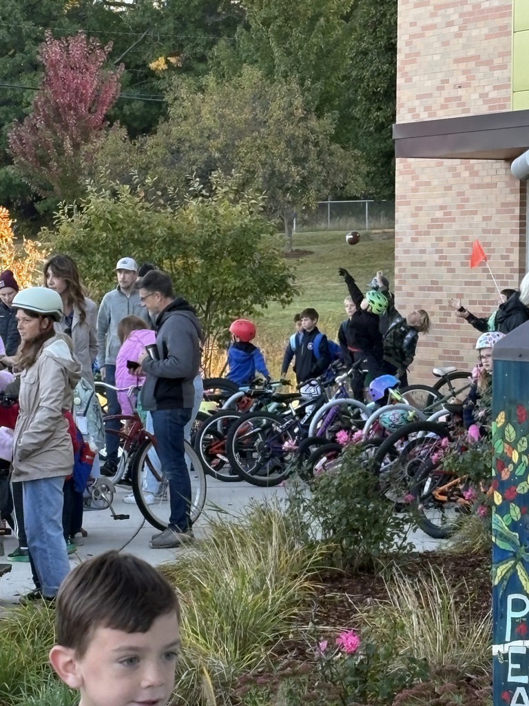 A crowd of students and parents by the bike corral