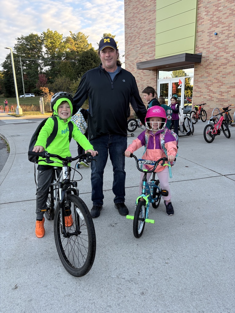 One adult and two students on bikes