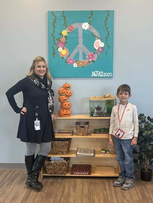 Teacher and student standing in the hallway