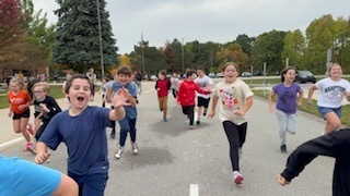 Move- A -Thon. A group of children running and smiling