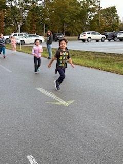 Move- A -Thon. Children smiling while running.