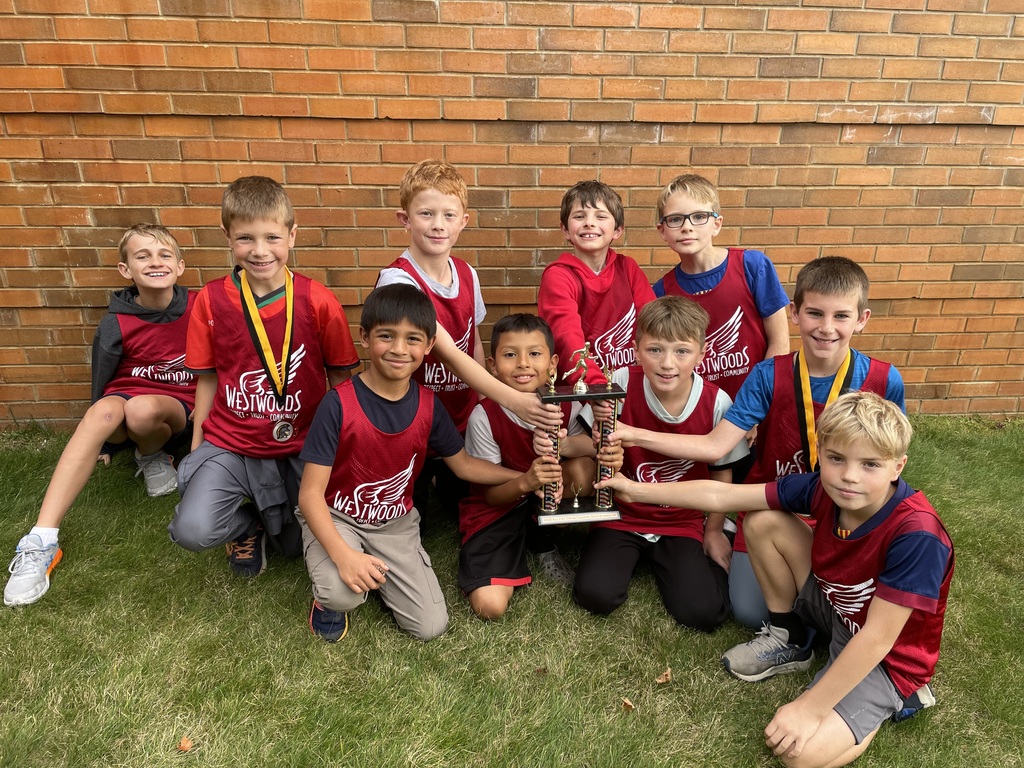 Westwoods Cross Country  boys Team took 2nd place! A group of children wearing westwood shirts holding a trouphey.
