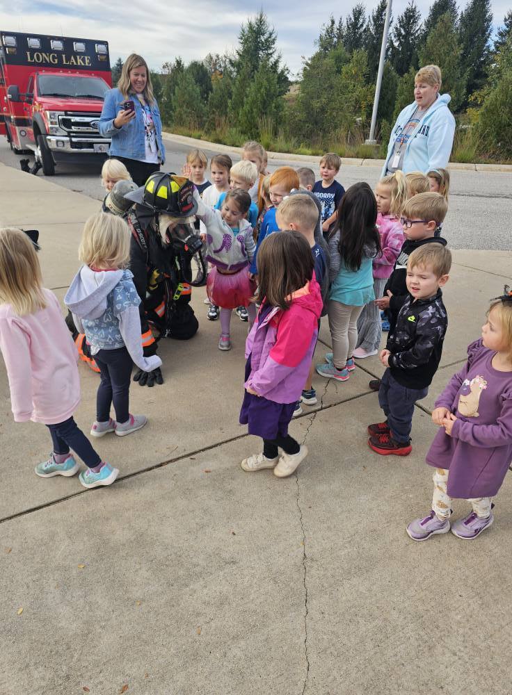 students standing in front of a fire truck