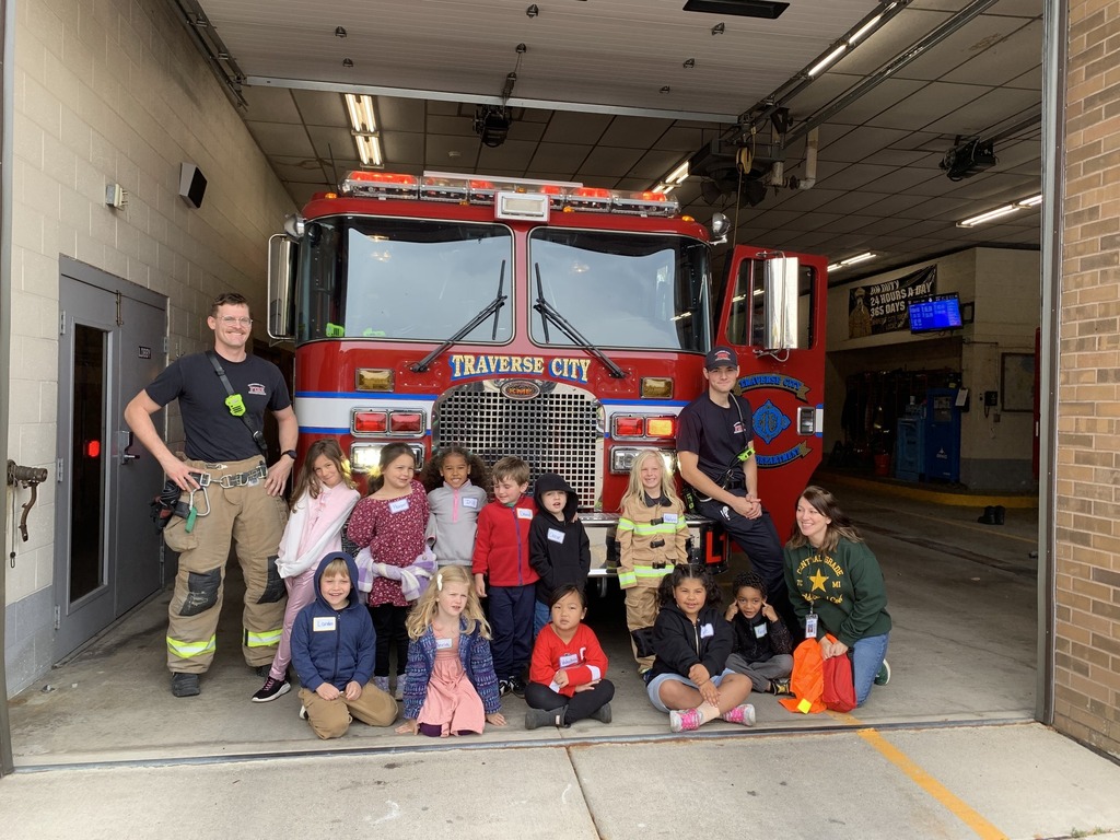 students standing in front of a fire truck