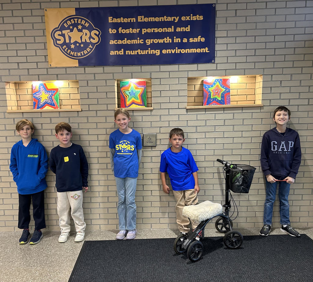 kids standing in front of a brick wall