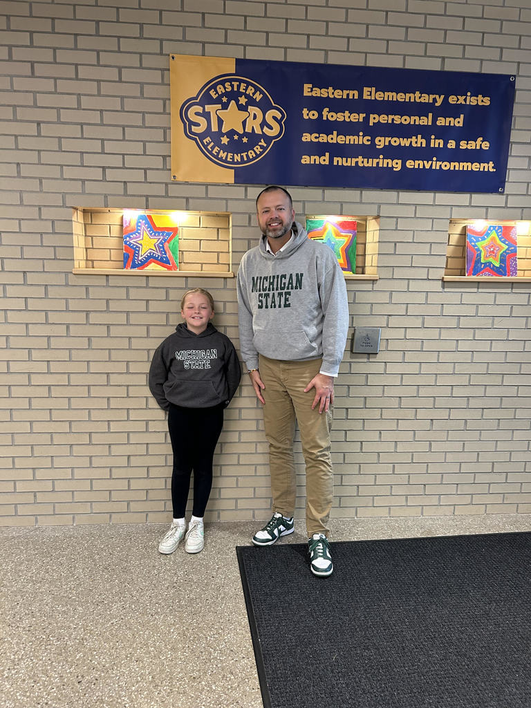 student and man standing in front of a brick wall
