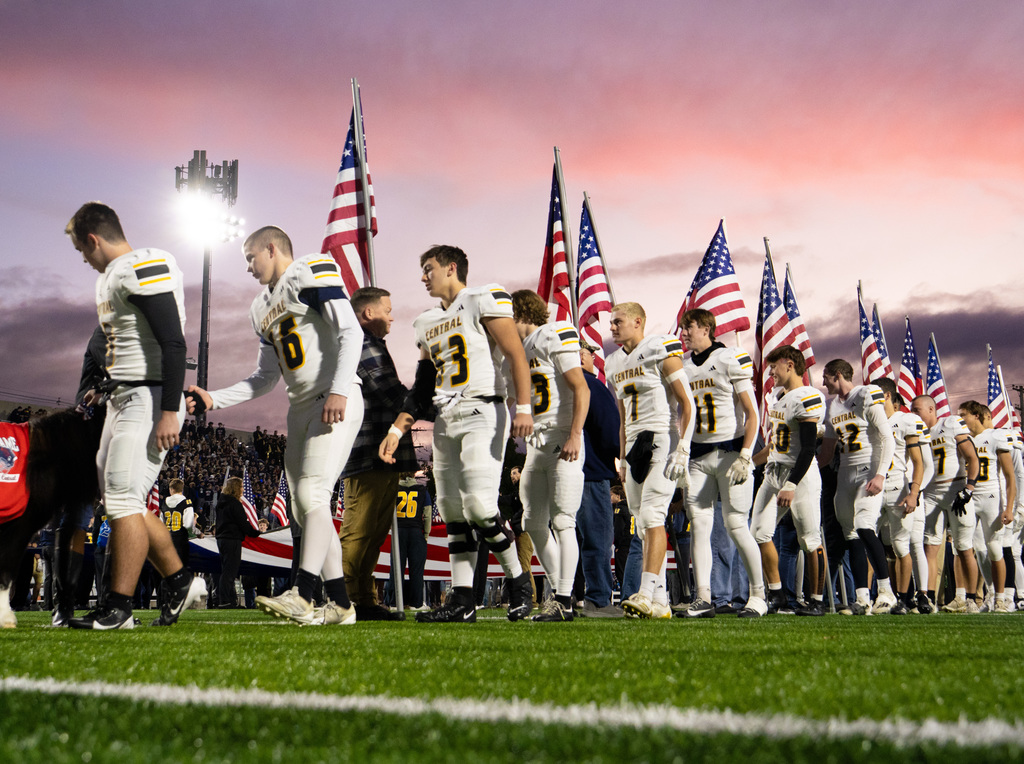 TC Central players shaking the hands of Veterans, first responders, active-duty military, and area heroes before kickoff on football field