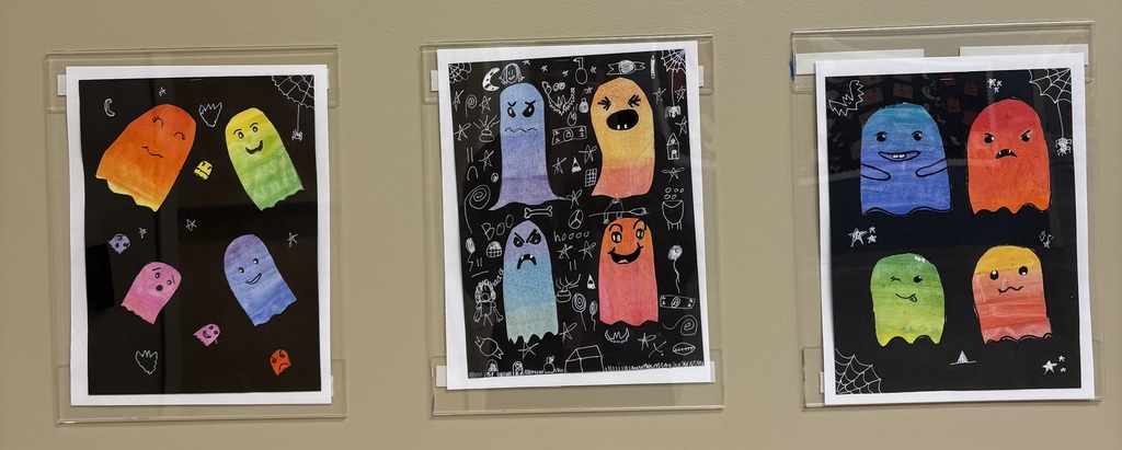 Ghost artwork in three frames on hallway wall