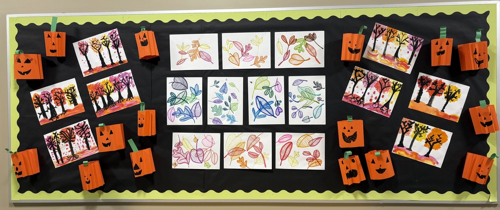 Fall and Halloween artwork on bulletin board