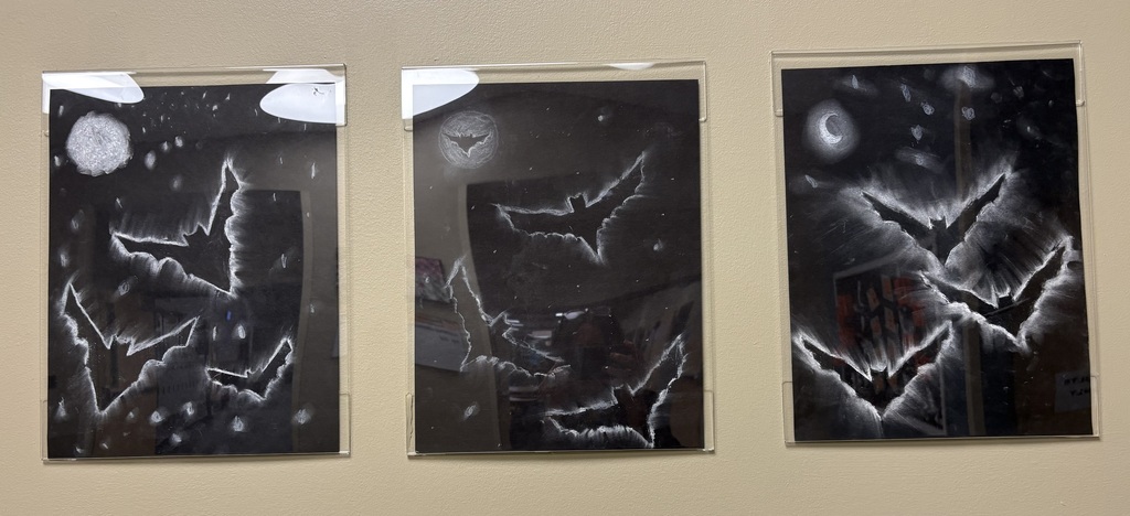 Three art pieces with chalk outlined bats