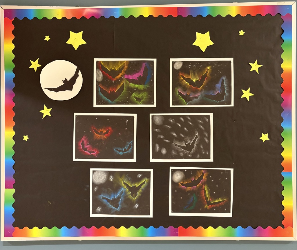Bulletin board with bat artwork with a black night sky background