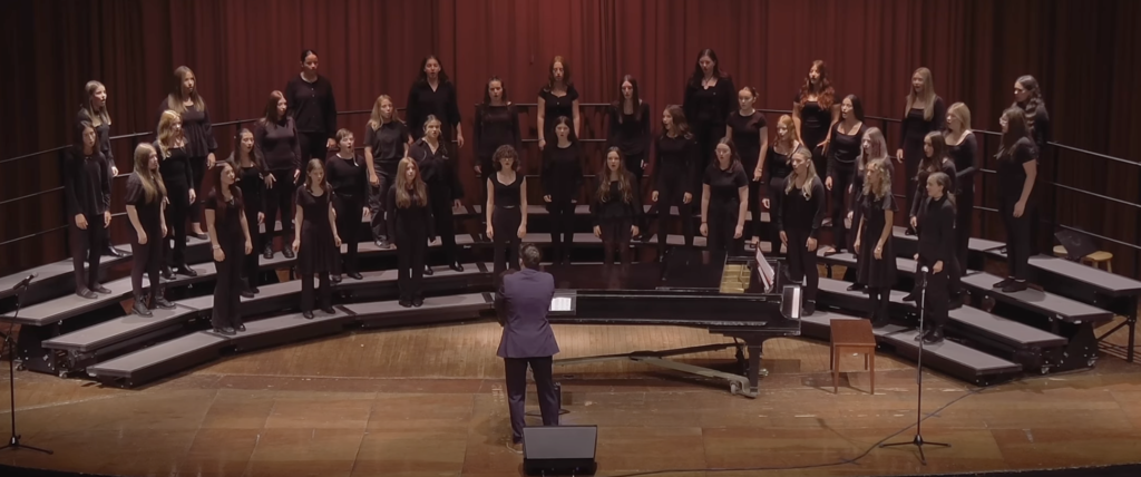 7th and 8th grade choir students on stage