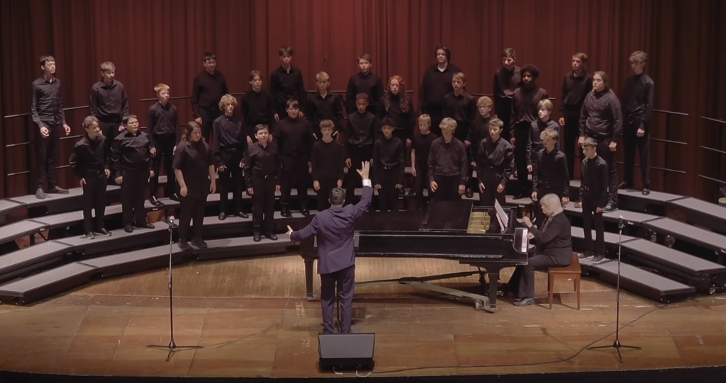 7th and 8th grade choir students on stage