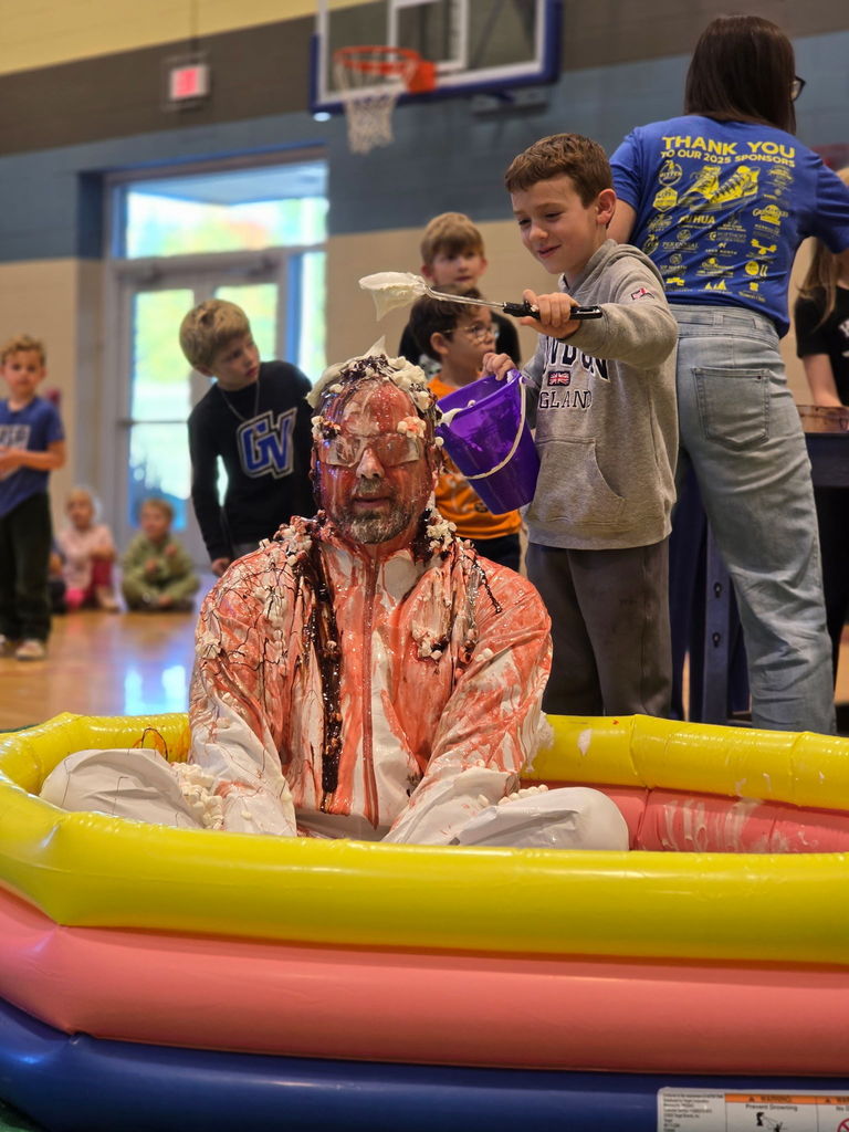 Students pouring ice cream on principal